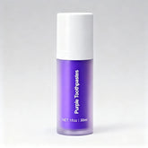 Purple toothpaste tube with white cap on a gray background