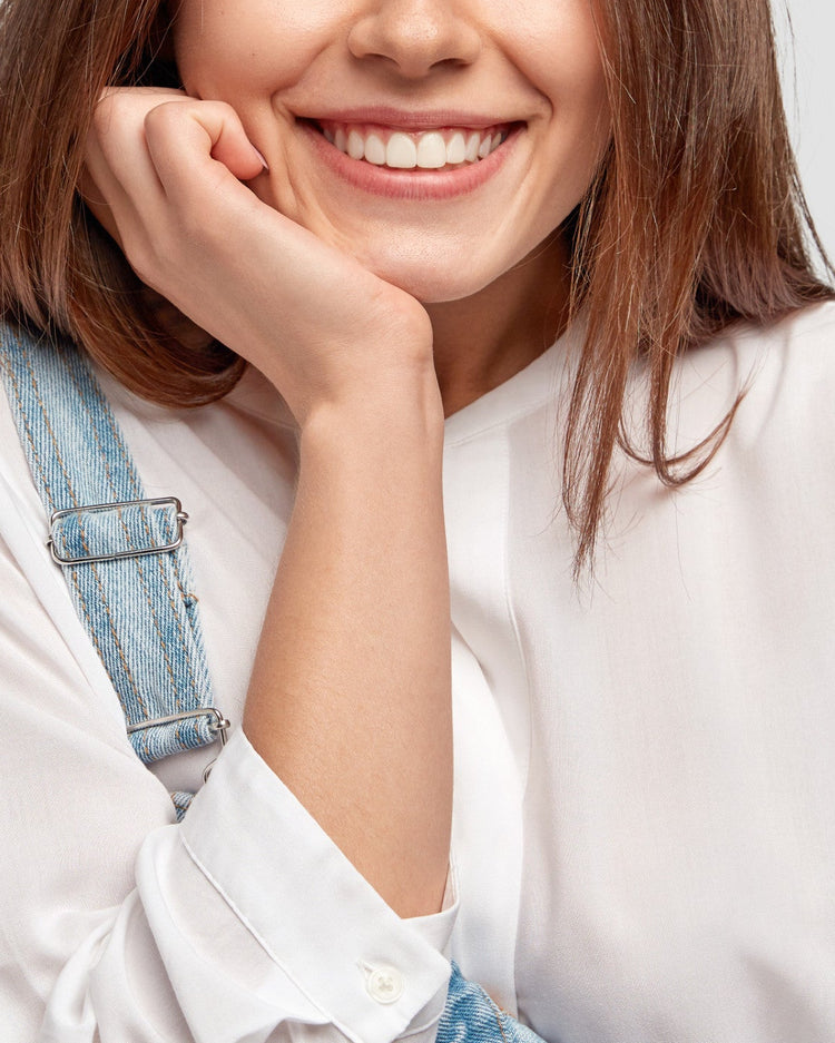 Woman with a smile on a plain background